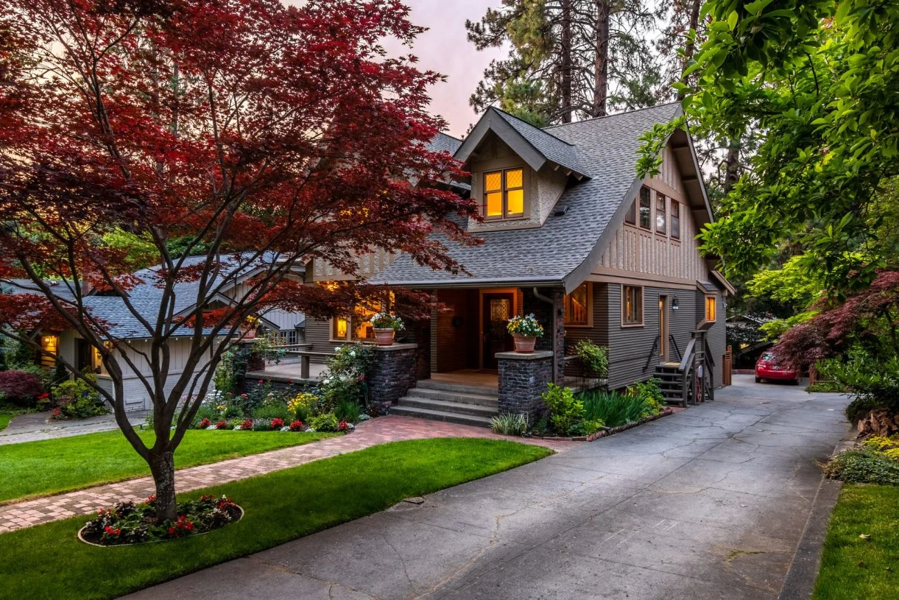 Suburban home with a red maple tree at twilight